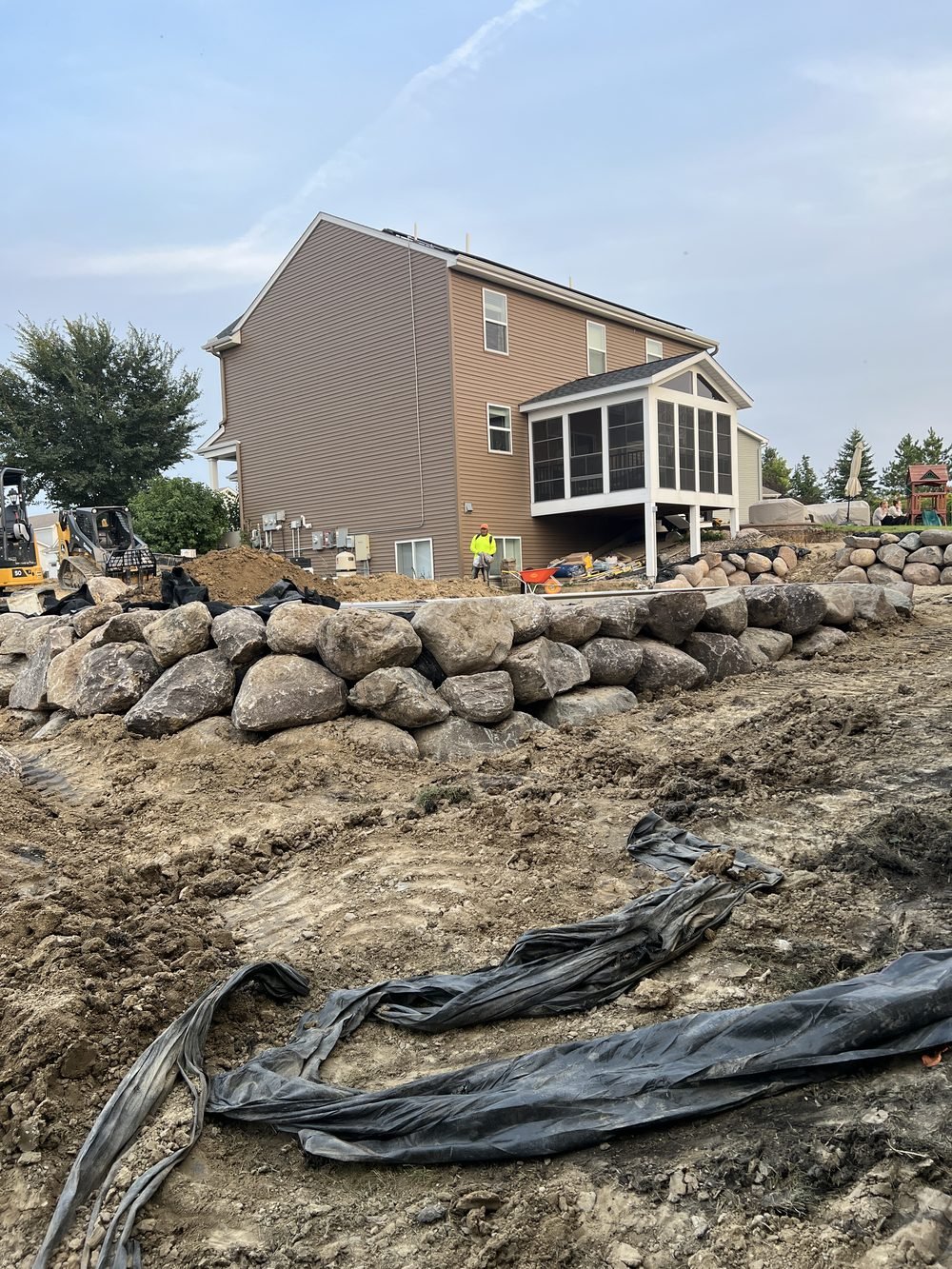 Boulder retaining wall landscape project by Lindquist Outdoor Services